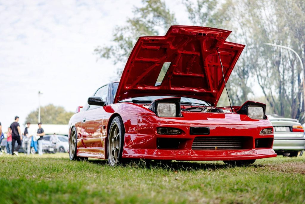 red nissan 240sx with hood open